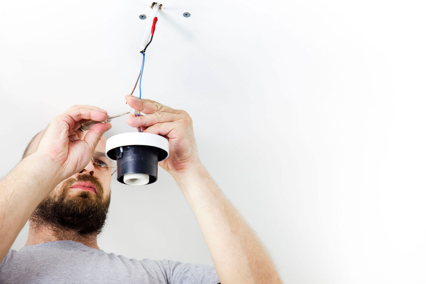 Electrician Installing Celling Light / House worker / Repairman / wiht white copy space (iStock_000016415437)